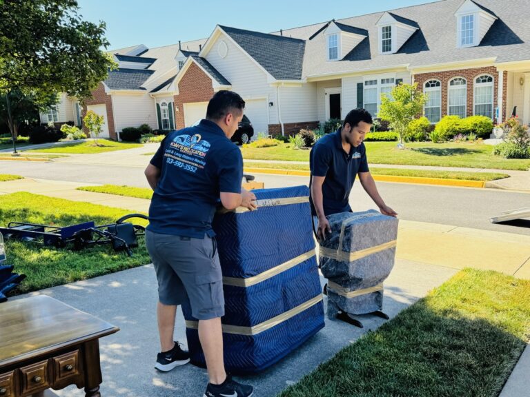 Moving crew transporting boxes and wrapped furniture during a mansion move in McLean VA