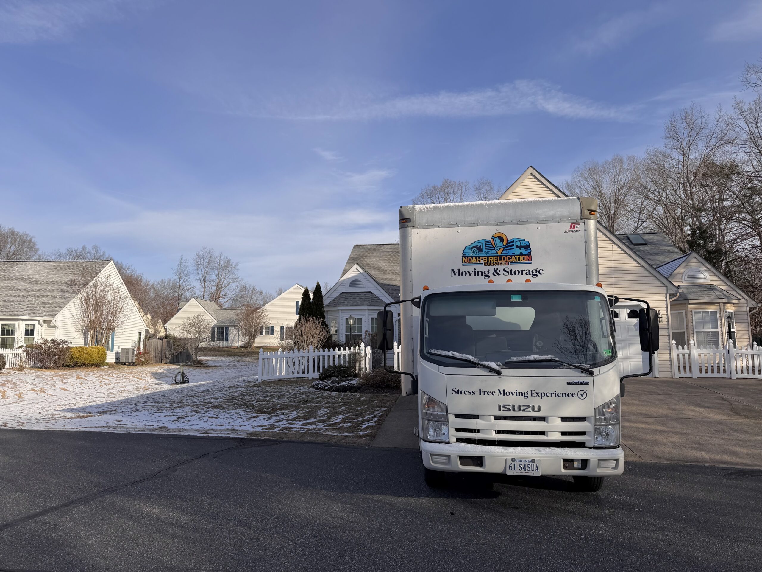 Professional interstate moving crew loading household goods into a moving truck for a long distance relocation